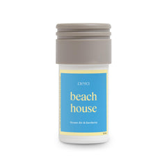 Aera Mini Beach House fragrance bottle close-up showing ocean air and gardenia notes.