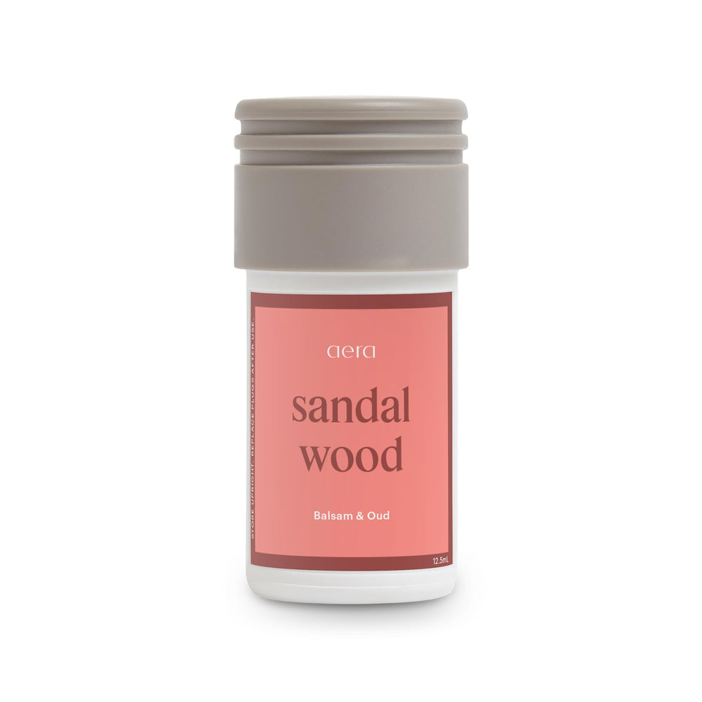 Aera Mini Sandalwood bottle cap close-up showing compact, refillable design for home use.