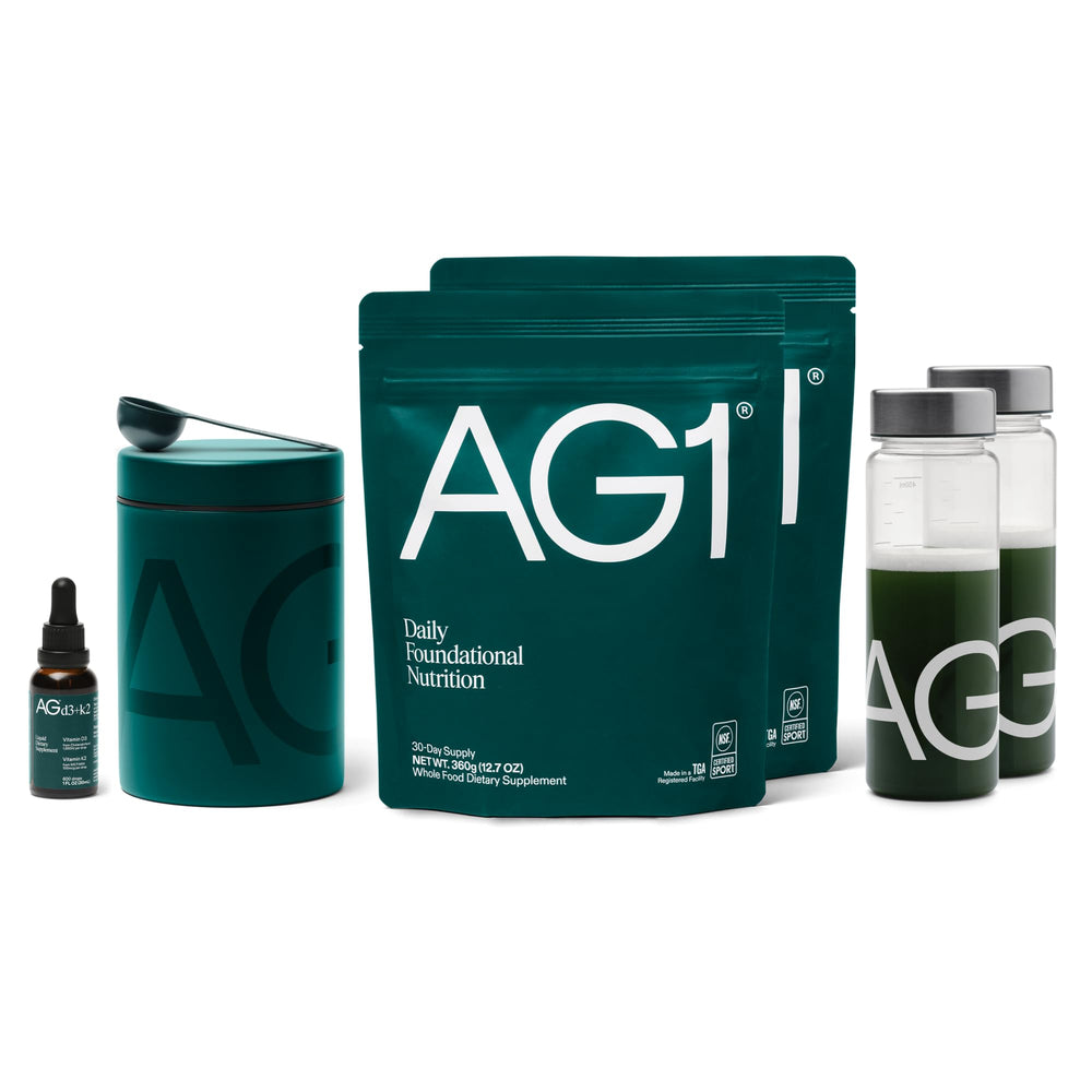 AG1 tub with scoop dispensing powder for easy daily use.