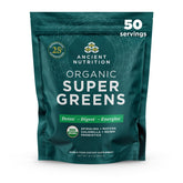 Ancient Nutrition Super Greens powder bottle on kitchen counter with probiotics