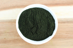 Anthony's chlorella powder blended into smoothie, emerald hue with nutrient-rich appeal.