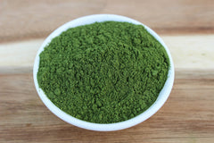Anthony's Wheatgrass Powder scoop with powder, perfect for adding to desserts or water shots.