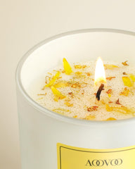 Dried flowers accent the candle for a stylish, gift-ready look.