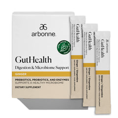 Arbonne Gut Health Digestion Drink Mix powder in a glass for balanced digestion and soothing taste.