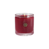 Aromatique The Smell of Christmas candle jar on a mantel creating warm, inviting ambiance.