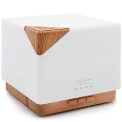 ASAKUKI 700ml diffuser releasing mist in a cozy room for calm ambiance.