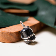 Ayana Wellness pendant worn on neck for grounding and calm.