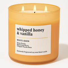 Bath and Body Works Whipped Honey Vanilla candle jar enhances cozy decor and ambience.