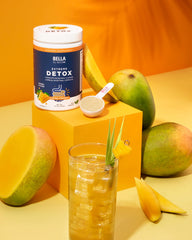 Scoop of Bella All Natural Detox Powder Mango for easy, on-the-go servings.