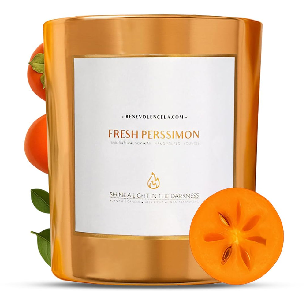 Benevolence LA Fresh Persimmon wood wick candle glowing in a festive setting for cozy holidays.