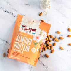 Bob's Red Mill almond protein powder in a baking dish for versatile recipes.