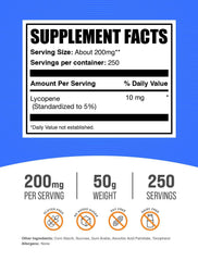 BulkSupplements Lycopene powder scoop beside glass of water for easy use.