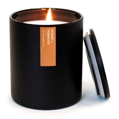 Calyan Cedar & Tobacco candle jar with cedar notes and warm glow.