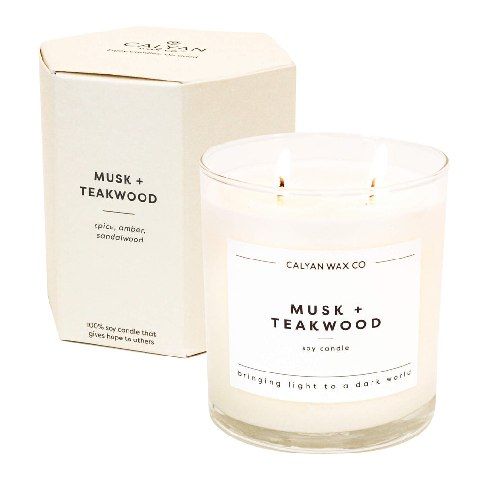 Calyan Musk Teakwood 2-Wick Candle in a glass jar for a warm, inviting ambiance.