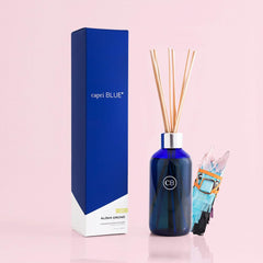 Capri Blue Aloha Orchid reed sticks ready to diffuse a floral scent.