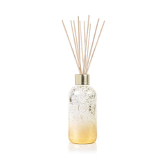 Capri Blue Glimmer diffuser in Volcano scent with winter design enhances living room ambiance