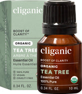 Cliganic Organic Tea Tree Oil bottle pour highlights purity for diffusers and calm spaces.