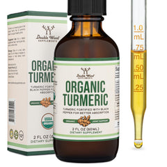 Double Wood Turmeric Drops bottle in hand for daily wellness.