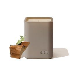 Drift teak scented candle in a sleek jar boosts living room ambiance.