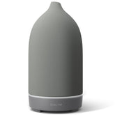 ENILYM aromatherapy diffuser in grey ceramic with a 9-color mood light for relaxing ambience.