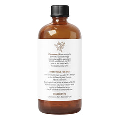 Essential Delights cinnamon essential oil bottle beside diffuser for home fragrance