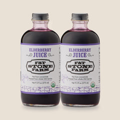 Fat Stone Farm elderberry juice bottle on kitchen counter, ready to mix beverages.