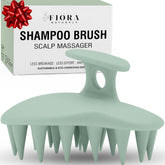 Fiora Naturals scalp massager brush close-up with ergonomic grip and silicone bristles.