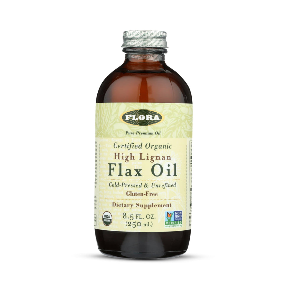 Flora High Lignan Flax Oil bottle on kitchen counter, ideal for adding EFAs to salads.