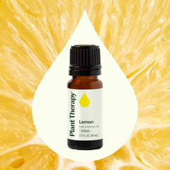 Fresh lemon slices sit beside the bottle to suggest scent and cleaning potential.