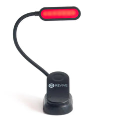 Gamma Revive 670nm red reading light on bed for low-blue-light reading.