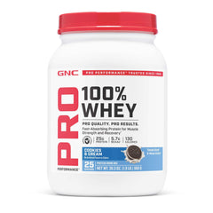 GNC Pro Performance 100% Whey Cookies Cream tub close-up highlighting flavor and gluten-free label