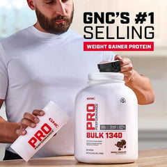 GNC Pro Performance Bulk 1340 scoop with powder and milk in a glass.