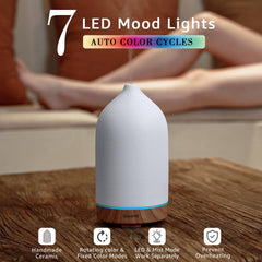 Close-up of Gooamp ceramic diffuser showing wood grain base and craftsmanship