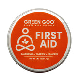 Green Goo tin open showing plant-based salve for quick skin relief.