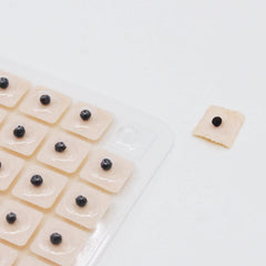 Hedigon ear seeds tweezers shown for precise placement.