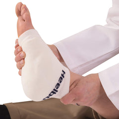 Heelbo protection sleeve side view shows slip-on fit that stays in place without restricting blood flow.