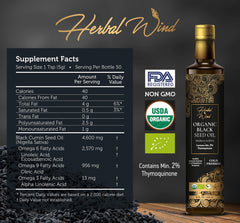Pouring Herbal Wind Black Seed Oil into a glass for digestive comfort.