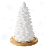 Honeydak Christmas tree diffuser on white ceramic for festive ambiance.