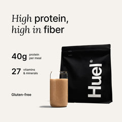 Glass with a creamy Huel Black Edition Cookies and Cream shake ready for a quick meal.