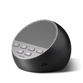 Idealsleep compact sound machine beside bed for travel.