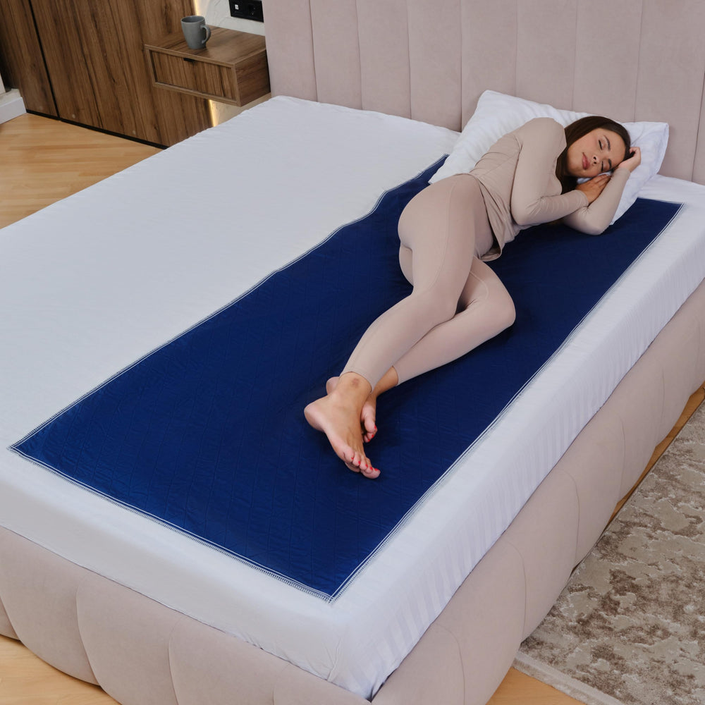 Inspire waterproof quilted mattress pad in dark navy protecting bed and hiding stains.