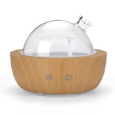 Kakoda glass diffuser with wood-grain base adds stylish ambiance to any room.