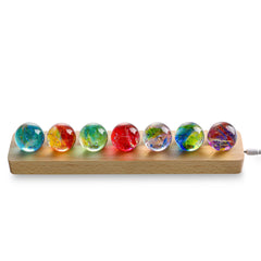 KRISININE seven chakra spheres glow softly on the stand for calming rituals