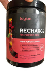Legion Recharge scoop measuring a serving for post-workout use.