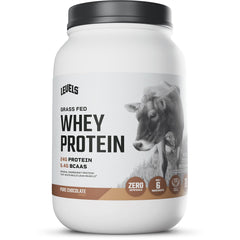 Levels Grass Fed Whey bottle on a kitchen counter showcasing clear packaging and label.