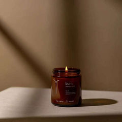 Maude Burn No. 3 melting wax highlights hydrating oil ready for skin application.