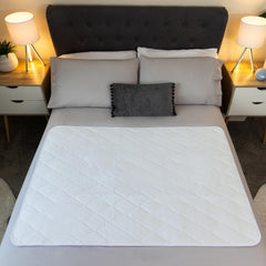 McLiberty 34x52 bed protector in use on a bed for adults