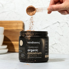 MINDHONEY colostrum bottle label highlights gluten-free and organic attributes for mindful choices.