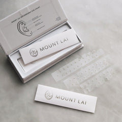 Applying Mount Lai ear seed to the ear for needle-free pressure