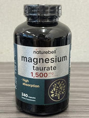 Close-up of NatureBell Magnesium Taurate capsules showing chelated design.